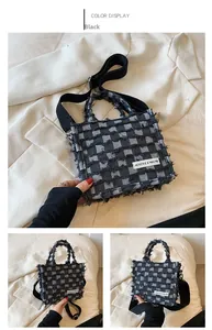 Detail of checkered tweed tote bag with fringe edges and black fabric shoulder strap