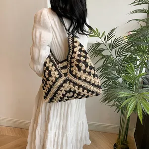 Detailed view of bohemian crochet shoulder bag with black and beige geometric pattern