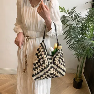 Detail of hand-crocheted tote bag with black and white geometric floral pattern