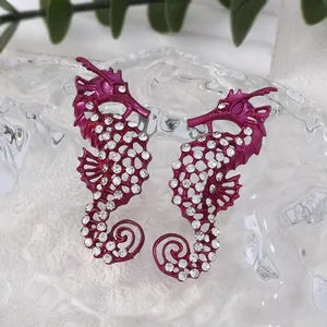 Vintage sea horse stud earrings in magenta with crystals and hollow design