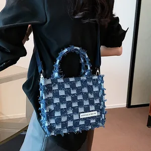 Blue denim checkerboard tote bag with fringe details and crossbody strap for women