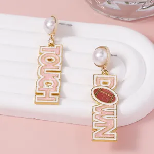 Golden American football earrings with pearls and TOUCH DOWN pink enamel letters