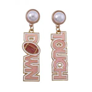 Detail of drop earrings featuring faux pearls and TOUCH DOWN football enamel charms