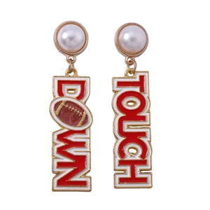Detailed view of pearl drop earrings with red and white Touch Down football text charms
