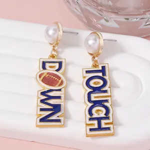 Faux pearl football drop earrings with blue Touch Down enamel lettering and gold accents