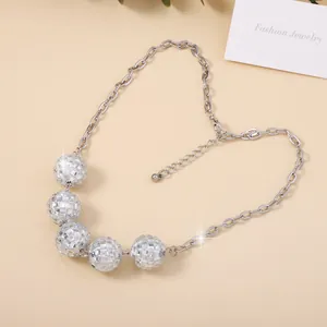 Silver disco ball necklace with five pave-set beads arranged in a heart shape display