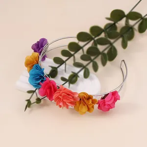 Macro detail of multi-colored floral headpiece with realistic fabric flower petals
