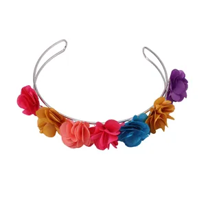 Detail of colorful fabric flower petals and silver metal frame on a floral headband