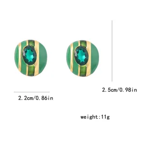 Vista de detalle de pendientes de esmalte verde y oro, ancho 2,2cm y altura 2,5cm