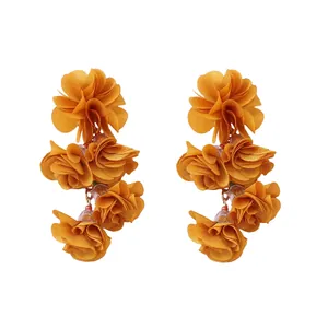 Detailansicht gelbe Boho-Stoffblumen-Ohrringe mit geschichteten floralen Blütenblättern