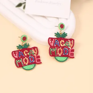 Colorful beaded VACAY MODE dangle earrings with vibrant embroidery and floral studs