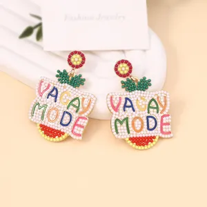Colorful handmade seed bead earrings with VACAY MODE text and floral studs for summer