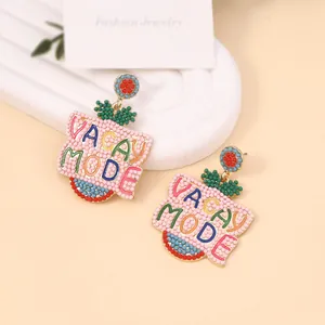 Macro shot of Vacay Mode beaded earrings with colorful handmade weaving and studs