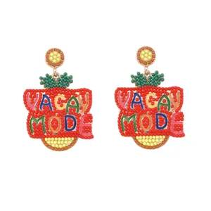 Handmade beaded Vacay Mode earrings in red and gold for a tropical summer beach look