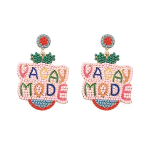 Macro detail of colorful seed bead earrings featuring woven VACAY MODE letter design