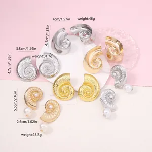Detail view of vintage seashell and pearl earrings in gold and silver finishes