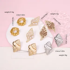 Detailed view of vintage sea shell earrings with imitation pearls and crystal inlay