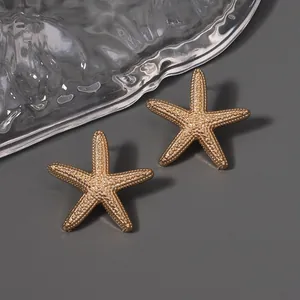 Chic golden starfish stud earrings with matte texture and zircon for beach vacations