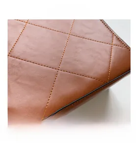Detail view of brown quilted leather texture with gold Fashion Bags lettering