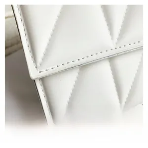 Macro shot of white leather texture with classic quilted diamond pattern stitching details