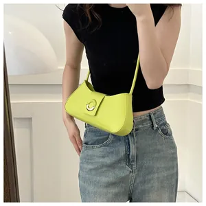Detail of trendy neon green underarm bag featuring a semi-circular metal buckle closure