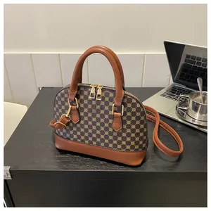 Detail of vintage Boston shell bag with geometric print and brown leather accents