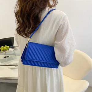 Blue quilted faux leather shoulder bag for women with elegant gold buckles for summer