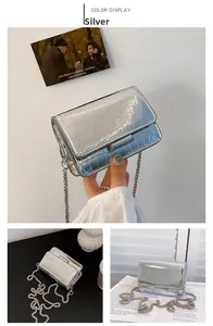 Detailed view of silver crocodile embossed faux leather bag with elegant metal chain strap