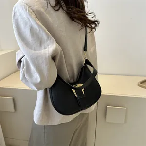 Chic black crocodile embossed crescent underarm bag with decorative gold buckle
