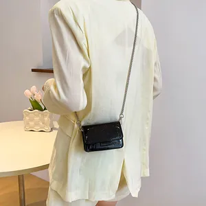Chic black crocodile embossed glossy leather crossbody bag with silver chain strap