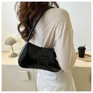 Detail view of a black retro PU underarm bag with a wide flap and large square buckle