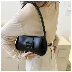 Minimalist black PU leather underarm bag with decorative metal square buckle detail