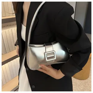 Close-up of trendy silver metallic underarm bag featuring a large square decorative buckle