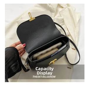 Detail view of black cross-grain leather saddle bag showing large internal capacity