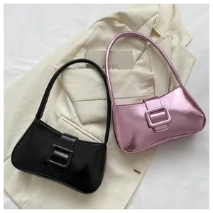 Detail view of stylish baguette bags in matte black and metallic pink with square buckles
