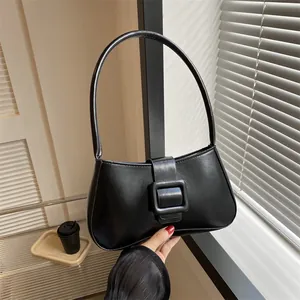 Minimalist black PU leather baguette bag with a signature oversized square buckle and top handle