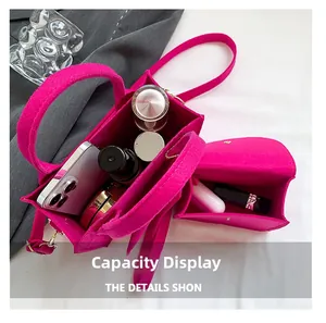Vue de la capacité du sac en feutre fuchsia avec téléphone et produits cosmétiques