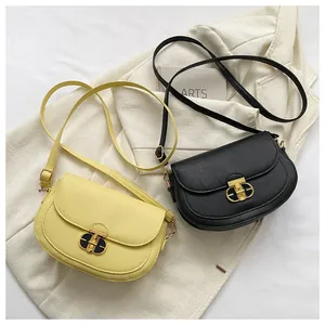 Detail of solid color saddle bags with lychee grain leather and golden T-bar metal locks