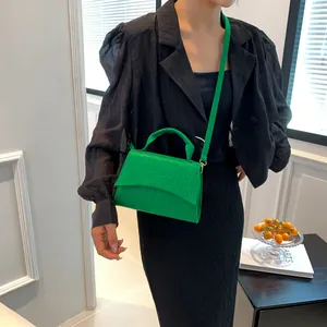 Bright green crocodile pattern felt crossbody bag with adjustable strap and top handle