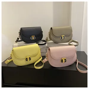 Detail of four colorful saddle bags in lychee leather with gold T-shaped metal buckles