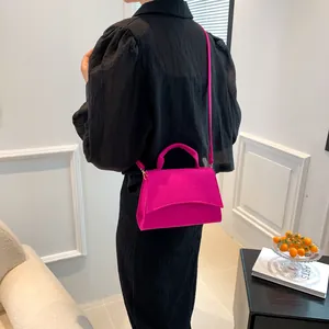 Elegant magenta crocodile pattern crossbody bag with top handle for women in minimalist setting