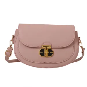 Pink minimalist saddle bag with crosshatch texture and golden T-shaped metal clasp