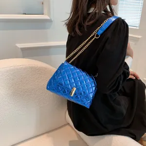 Blue quilted chain shoulder bag with metallic finish and gold lock for women