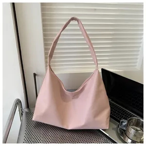 Minimalist pale pink large tote bag shown in a professional modern office setting
