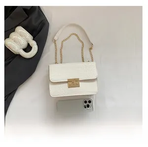 White crocodile pattern crossbody bag with gold chain and phone for size reference