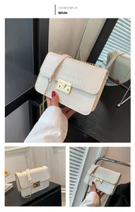 Detail of white crocodile pattern shoulder bag with gold square buckle and chain strap