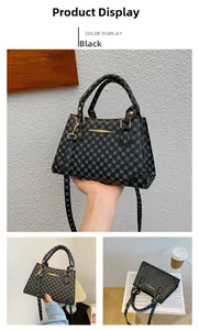 Detail of black handbag with blue dot pattern featuring gold hardware and a long strap