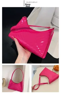 Close-up of rose red patent leather shoulder bag with V-shaped geometric quilting details
