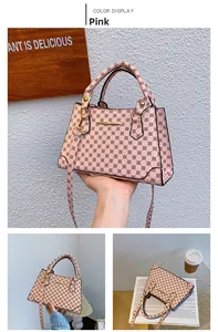 Detailed view of pink monogram handbag with gold buckle and adjustable strap