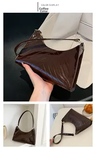 Detailed view of coffee brown patent leather shoulder bag with V-shaped quilted texture